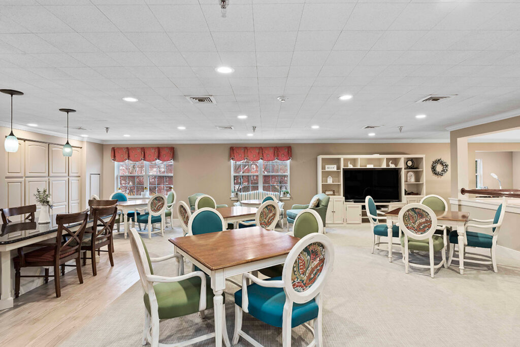 Kindred Place at Annville senior apartments view of activity area with many spaces, a tv, tables