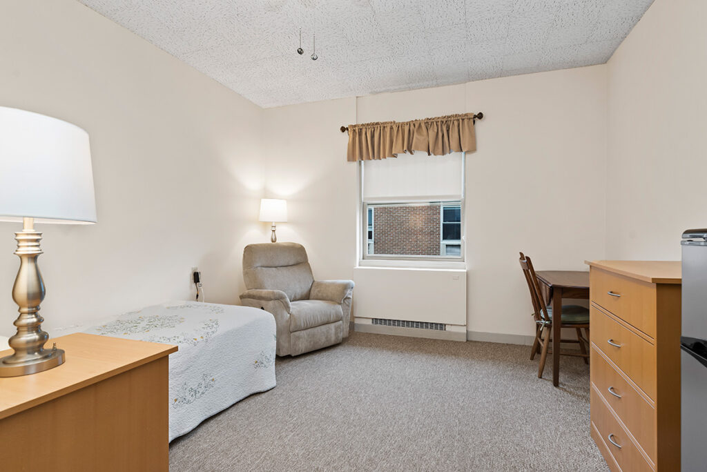 single bed, chair, table, dresser view of personal care room at Lebanon Valley Home
